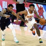 Phoenix Suns guard Cameron Payne (15) drives past Dallas Mavericks Trey Burke during the second half of an NBA basketball game Wednesday, Dec. 23, 2020, in Phoenix. (AP Photo/Rick Scuteri)
