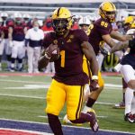 Arizona State running back DeaMonte Trayanum (1) scores a touchdown against Arizona during the first half of an NCAA college football game, Friday, Dec. 11, 2020, in Tucson, Ariz. (AP Photo/Rick Scuteri)
