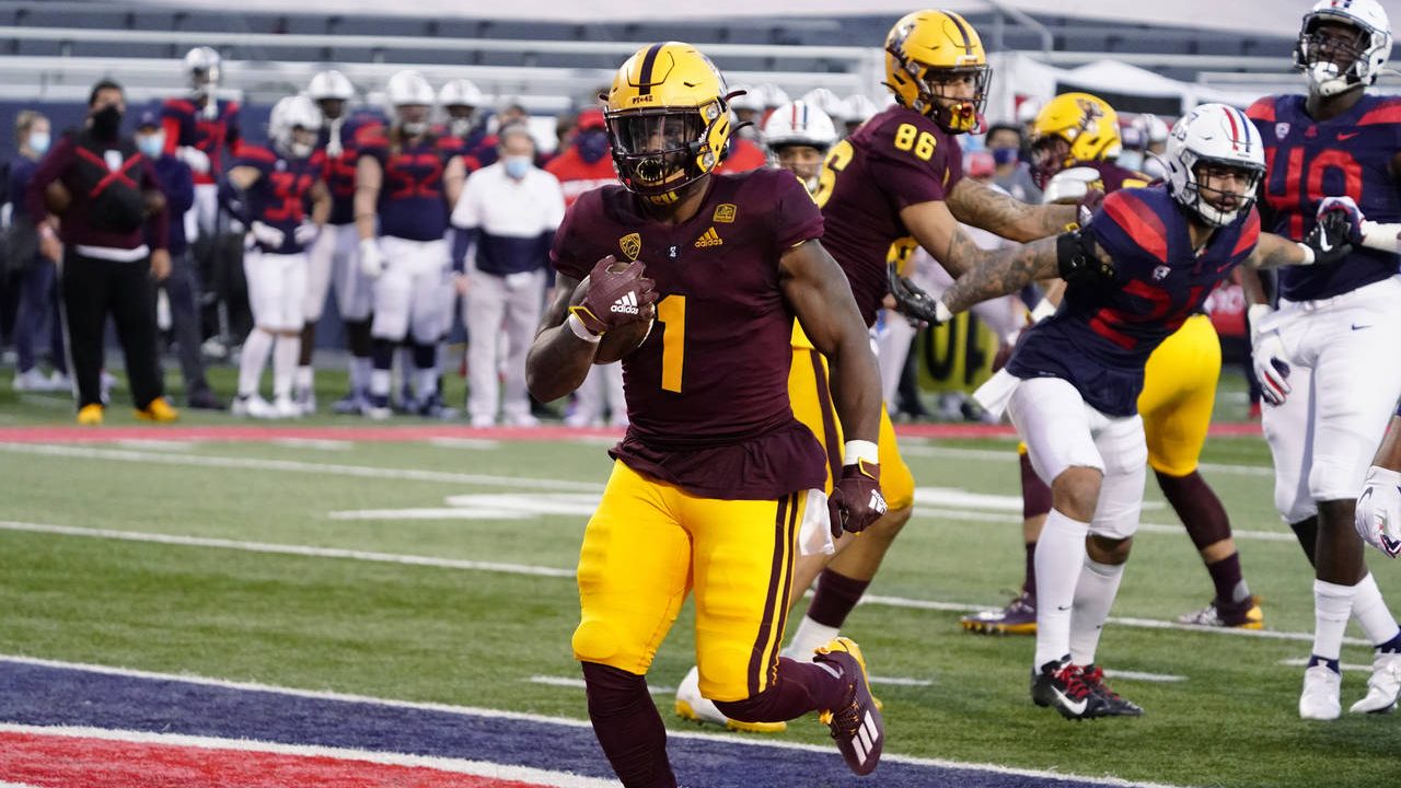 Arizona State running back DeaMonte Trayanum (1) scores a touchdown against Arizona during the firs...