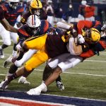 Arizona State running back Jackson He (32) scores a touchdown with Arizona defensive back Jaxen Turner trying to defend in the second half during an NCAA college football game, Friday, Dec. 11, 2020, in Tucson, Ariz. (AP Photo/Rick Scuteri)