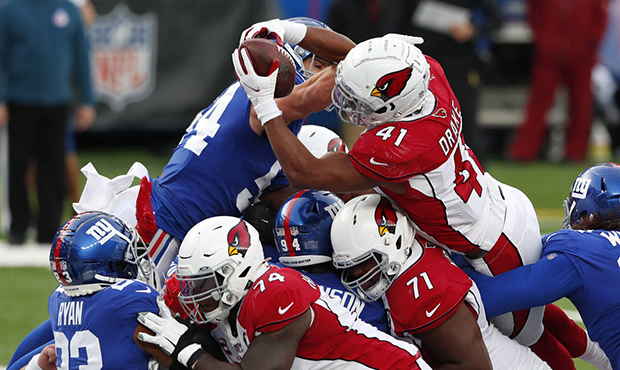 Arizona Cardinals' Kenyan Drake (41), top right, leaps over New York Giants defenders to score a to...