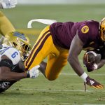 Arizona State wide receiver Jordan Kerley is tackled by UCLA defensive back John Humphrey (6) during the first half of an NCAA college football game Saturday, Dec. 5, 2020, in Tempe, Ariz. (AP Photo/Matt York)
