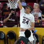 Arizona State forward Jalen Graham (24) dunks over San Diego State forward Nathan Mensah (31) during the second half of an NCAA college basketball game Thursday, Dec. 10, 2020, in Tempe, Ariz. (AP Photo/Ross D. Franklin)