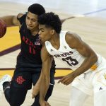 San Diego State forward Matt Mitchell (11) collides with Arizona State guard Josh Christopher (13) during the second half of an NCAA college basketball game Thursday, Dec. 10, 2020, in Tempe, Ariz. (AP Photo/Ross D. Franklin)