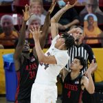 Arizona State forward Jalen Graham, middle, gets off a shot as San Diego State forward Nathan Mensah (31) and guard Trey Pulliam (4) defend during the second half of an NCAA college basketball game Thursday, Dec. 10, 2020, in Tempe, Ariz. San Diego State won 80-68. (AP Photo/Ross D. Franklin)