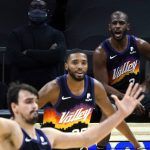 Phoenix Suns guard Chris Paul, right, yells out to his teammates from the bench during the second half of the Suns' NBA basketball game against the New Orleans Pelicans, Tuesday, Dec. 29, 2020, in Phoenix. (AP Photo/Rick Scuteri)