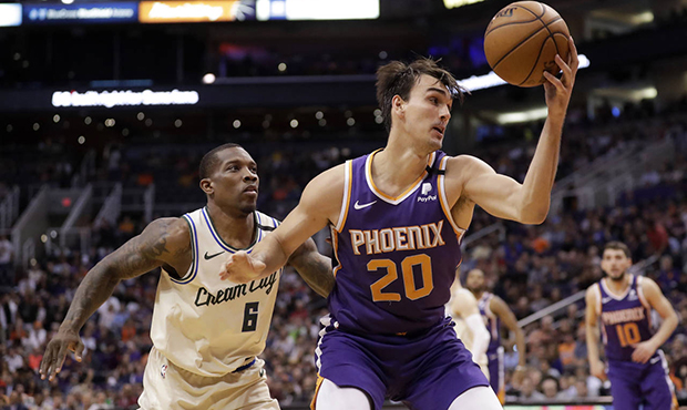 Phoenix Suns forward Dario Saric (20) drives around Milwaukee Bucks guard Eric Bledsoe (6) during t...