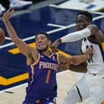 Phoenix Suns guard Devin Booker (1) and Utah Jazz guard Miye Oni, right, vie for a rebound during the first half of an NBA preseason basketball game Saturday, Dec. 12, 2020, in Salt Lake City. (AP Photo/Rick Bowmer)