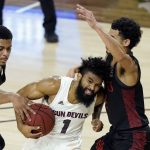 Arizona State guard Remy Martin (1) tries to drive past San Diego State forward Matt Mitchell, left, and guard Trey Pulliam, right, during the first half of a college basketball game Thursday, Dec. 10, 2020, in Tempe, Ariz. (AP Photo/Ross D. Franklin)