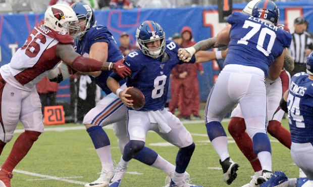 New York Giants quarterback Daniel Jones, center, tries to evade the Arizona Cardinals defense duri...