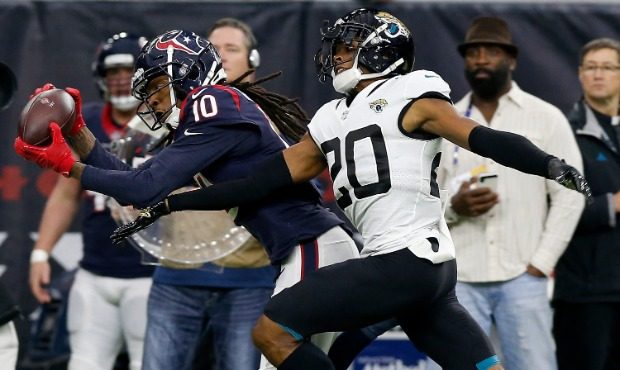 DeAndre Hopkins #10 of the Houston Texans makes a catch defended by Jalen Ramsey #20 of the Jackson...
