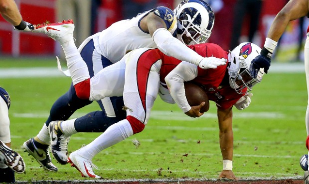 Arizona Cardinals quarterback Kyler Murray, right, is sacked by Los Angeles Rams defensive end Mich...
