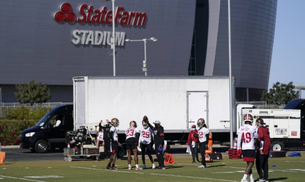 San Francisco 49ers defensive players run drills during NFL football practice in front of State Far...