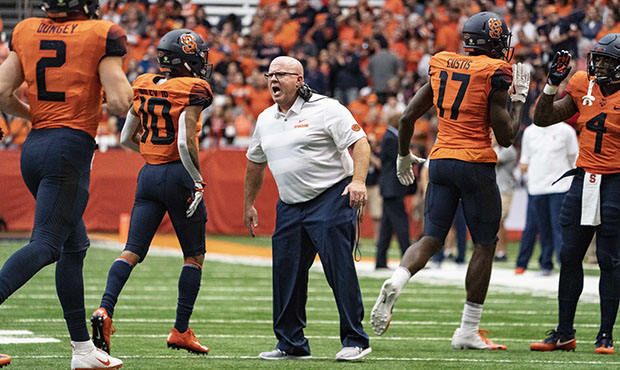 Syracuse Orange Offensive Lineman Coach Mike Cavanaugh greets players after scoring a touchdown dur...