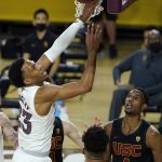 Arizona State forward Marcus Bagley (23) loses control of the ball as USC forward Isaiah Mobley (3) and forward Evan Mobley (4) look on during the first half of an NCAA men's college basketball game Saturday, Jan. 9, 2021, in Tempe, Ariz. (AP Photo/Ross D. Franklin)