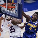 Indiana Pacers' Victor Oladipo (4) dunks against Phoenix Suns' Mikal Bridges (25) during the second half of an NBA basketball game, Saturday, Jan. 9, 2021, in Indianapolis. (AP Photo/Darron Cummings)