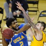 UCLA forward Cody Riley (2) is fouled by Arizona State forward Chris Osten during overtime of an NCAA college basketball game Thursday, Jan. 7, 2021, in Tempe, Ariz. UCLA won 81-75. (AP Photo/Ross D. Franklin)