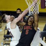 Southern California guard Isaiah White (5) goes up for a shot against Arizona State forward Chris Osten, left, during the second half of an NCAA college basketball game Saturday, Jan. 9, 2021, in Tempe, Ariz. USC won 73-64. (AP Photo/Ross D. Franklin)