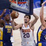 Phoenix Suns' Dario Saric (20) shoots against Indiana Pacers' Myles Turner (33) and Domantas Sabonis (11) during the first half of an NBA basketball game, Saturday, Jan. 9, 2021, in Indianapolis. (AP Photo/Darron Cummings)