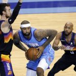 Houston Rockets center DeMarcus Cousins, middle, looks to pass the ball under pressure from Phoenix Suns forward Frank Kaminsky (8) and guard Jevon Carter (4) during the first half of an NBA basketball game Wednesday, Jan. 20, 2021, in Houston. (AP Photo/Michael Wyke)