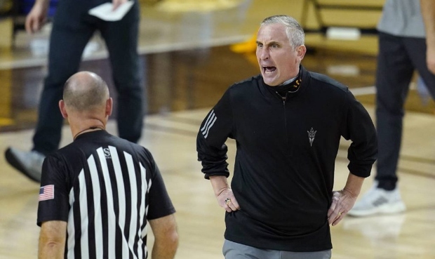 Arizona State coach Bobby Hurley, right, argues with an official after one of his players was issue...