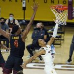 USC forward Evan Mobley (4) defends against a shot from Arizona State guard Alonzo Verge Jr. (11) as USC guard Tahj Eaddy (2) looks on during the first half of an NCAA men's college basketball game Saturday, Jan. 9, 2021, in Tempe, Ariz. (AP Photo/Ross D. Franklin)