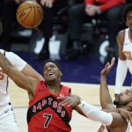 Toronto Raptors guard Kyle Lowry (7) battles with Phoenix Suns guard Jevon Carter, front right, for the ball as Suns forward Cameron Johnson (23) and guard Langston Galloway (2) look on during the first half of an NBA basketball game Wednesday, Jan. 6, 2021, in Phoenix. (AP Photo/Ross D. Franklin)