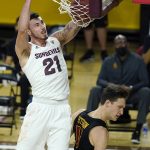 Arizona State forward Chris Osten, left, dunks on USC guard Drew Peterson, right, during the first half of an NCAA men's college basketball game Saturday, Jan. 9, 2021, in Tempe, Ariz. (AP Photo/Ross D. Franklin)