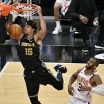 Memphis Grizzlies forward Brandon Clarke (15) dunks ahead of Phoenix Suns guard Chris Paul (3) in the first half of an NBA basketball game Monday, Jan. 18, 2021, in Memphis, Tenn. (AP Photo/Brandon Dill)