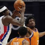 Phoenix Suns guard Langston Galloway, right, knocks the ball away from Detroit Pistons center Isaiah Stewart (28) during the first half of an NBA basketball game Friday, Jan. 8, 2021, in Detroit. (AP Photo/Carlos Osorio)