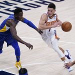 Phoenix Suns' Devin Booker (1) heads to the basket against Indiana Pacers' Victor Oladipo (4) during the first half of an NBA basketball game, Saturday, Jan. 9, 2021, in Indianapolis. (AP Photo/Darron Cummings)