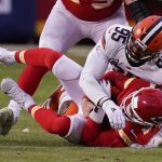 Kansas City Chiefs quarterback Chad Henne is sacked by Cleveland Browns defensive end Myles Garrett (95) during the second half of an NFL divisional round football game, Sunday, Jan. 17, 2021, in Kansas City. (AP Photo/Charlie Riedel)