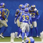 Los Angeles Rams cornerback Troy Hill (22) is congratulated by teammates after returning an interception for a touchdown against the Arizona Cardinals during the first half of an NFL football game in Inglewood, Calif., Sunday, Jan. 3, 2021. (AP Photo/Jae C. Hong)