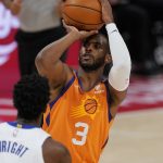 Phoenix Suns guard Chris Paul (3) attempts a three-point basket during the first half of an NBA basketball game against the Detroit Pistons, Friday, Jan. 8, 2021, in Detroit. (AP Photo/Carlos Osorio)