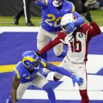 Los Angeles Rams cornerback Jalen Ramsey (20) and free safety John Johnson III, bottom, defend a pass intended for Arizona Cardinals wide receiver DeAndre Hopkins (10) during the second half of an NFL football game in Inglewood, Calif., Sunday, Jan. 3, 2021. (AP Photo/Jae C. Hong)