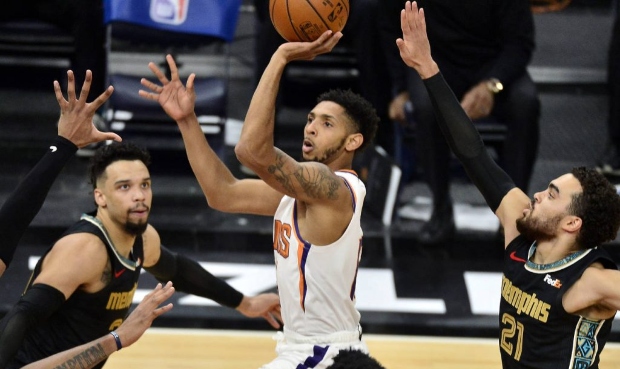 Phoenix Suns guard Cameron Payne (15) shoots between Memphis Grizzlies guards Dillon Brooks (24) an...