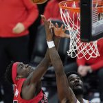 Phoenix Suns center Deandre Ayton, right, gets off a shot as Toronto Raptors forward Pascal Siakam, left, defends during the second half of an NBA basketball game Wednesday, Jan. 6, 2021, in Phoenix. The Suns defeated the Raptors 123-115. (AP Photo/Ross D. Franklin)