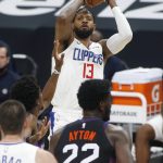 Los Angeles Clippers forward Paul George (13) shoots over the defense of Phoenix Suns guard Langston Galloway during the first half of an NBA basketball game Sunday, Jan. 3, 2021, in Phoenix. (AP Photo/Ralph Freso)