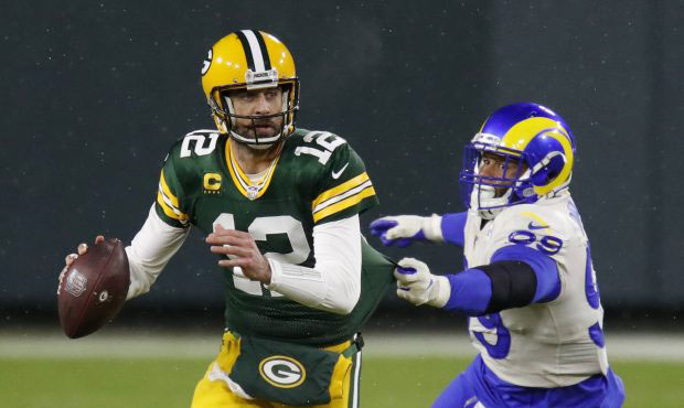 Green Bay Packers quarterback Aaron Rodgers (12) throws under pressure from Los Angeles Rams' Aaron...