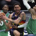 Phoenix Suns forward Abdel Nader (11) tries to go up for a shot against Dallas Mavericks center Willie Cauley-Stein, right, during the first half during an NBA basketball game Saturday, Jan. 30, 2021, in Dallas. (AP Photo/ Richard W. Rodriguez)