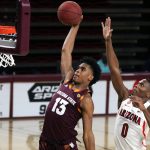 Arizona State guard Josh Christopher (13) dunks in front of Arizona guard Bennedict Mathurin during the first half of an NCAA college basketball game Thursday, Dec. 21, 2021, in Tempe, Ariz. (AP Photo/Rick Scuteri)