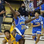 UCLA forward Jalen Hill (24) reaches up for a rebound over Arizona State forward Kimani Lawrence (4) during the second half of an NCAA college basketball game Thursday, Jan. 7, 2021, in Tempe, Ariz. (AP Photo/Ross D. Franklin)