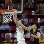 USC forward Max Agbonkpolo (23) stops a dunk by Arizona State forward Chris Osten, left, during the second half of an NCAA men's college basketball game Saturday, Jan. 9, 2021, in Tempe, Ariz. (AP Photo/Ross D. Franklin)