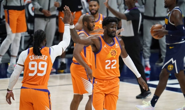 Phoenix Suns forward Jae Crowder, left, congratulates center Deandre Ayton, who scored and was foul...