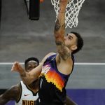 Phoenix Suns forward Abdel Nader (11) shoots next to Denver Nuggets forward JaMychal Green during the second half of an NBA basketball game Saturday, Jan. 23, 2021, in Phoenix. (AP Photo/Rick Scuteri)