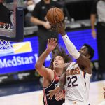 Phoenix Suns center Deandre Ayton (22) goes to the basket against Washington Wizards center Robin Lopez, left, during the first half of an NBA basketball game, Monday, Jan. 11, 2021, in Washington. (AP Photo/Nick Wass)