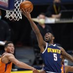 Denver Nuggets guard Will Barton drives for a basket past Phoenix Suns guards Devin Booker, back left, and Chris Paul during the second half of an NBA basketball game Friday, Jan. 1, 2021, in Denver. The Suns won 106-103. (AP Photo/David Zalubowski)