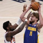 Indiana Pacers' Domantas Sabonis shoots over Phoenix Suns' Deandre Ayton during the second half of an NBA basketball game, Saturday, Jan. 9, 2021, in Indianapolis. (AP Photo/Darron Cummings)