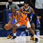 Phoenix Suns guard Chris Paul, left, pulls in a loose ball as Denver Nuggets guard Gary Harris defends during the second half of an NBA basketball game Friday, Jan. 1, 2021, in Denver. The Suns won 106-103. (AP Photo/David Zalubowski)