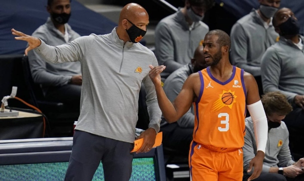 Phoenix Suns coach Monty Williams, left, confers with guard Chris Paul during the first half of the...